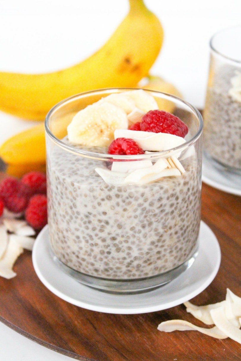 banana chia pudding with coconut milk and raspberries in a jar