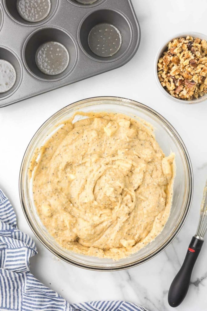 muffin batter with chopped walnuts in a bowl