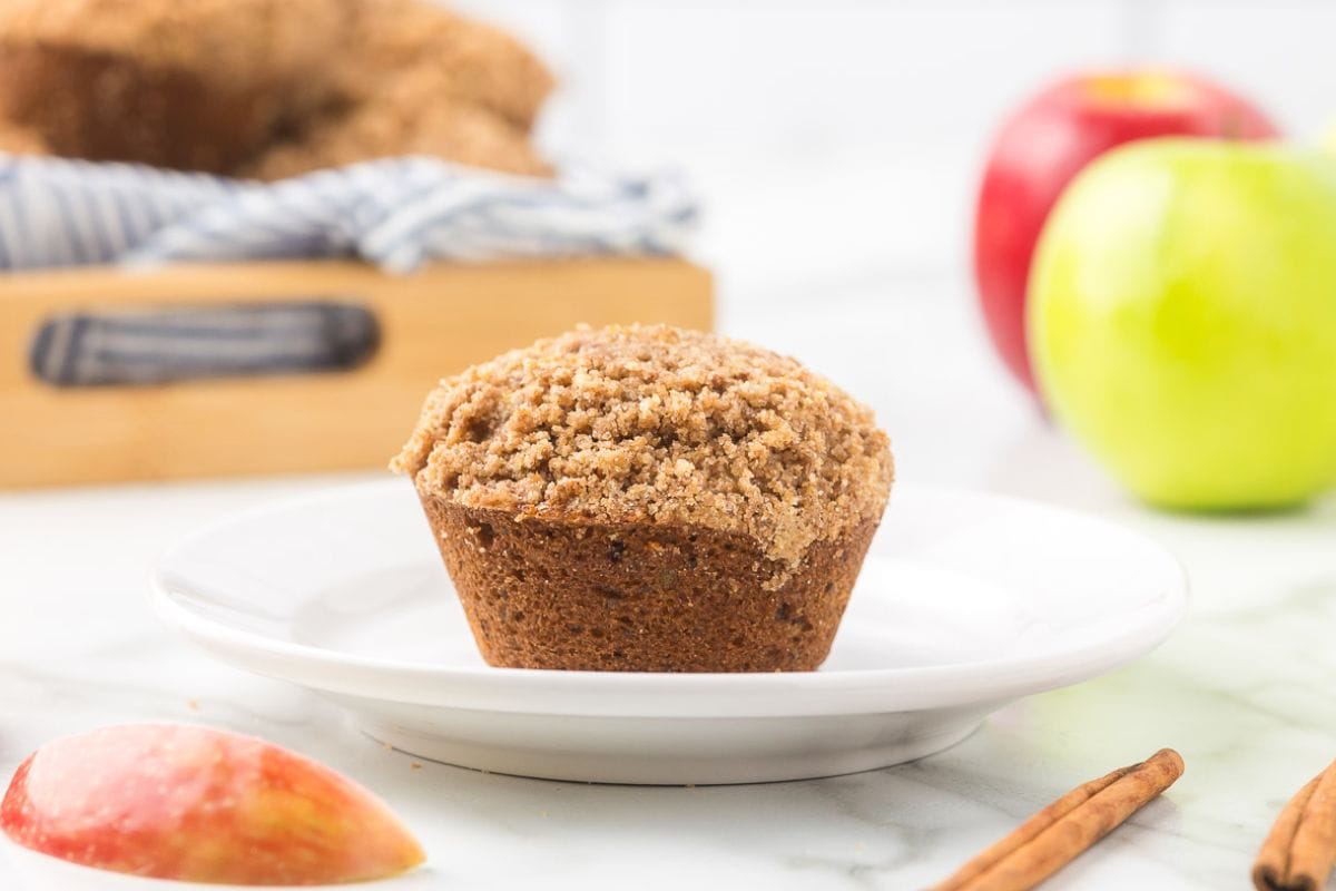 cinnamon apple crumble muffin on a white plate