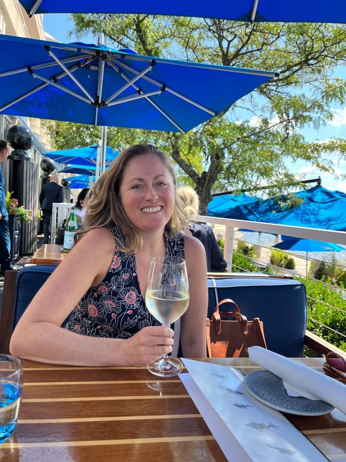 anne mauney holding a glass of prosecco