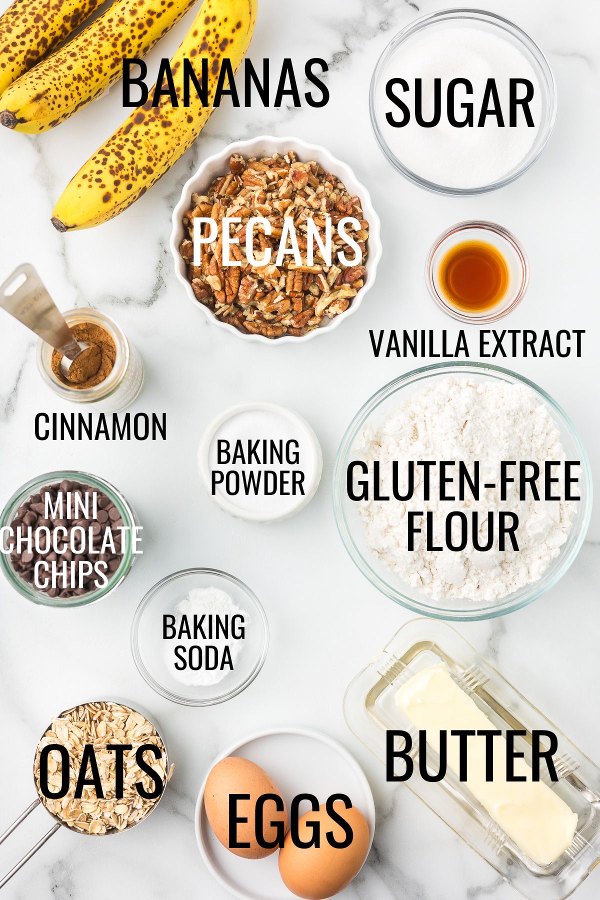 gluten free flour, butter, eggs, oats, sugar, bananas, pecans, chocolate chips, and other baking ingredients in small bowls