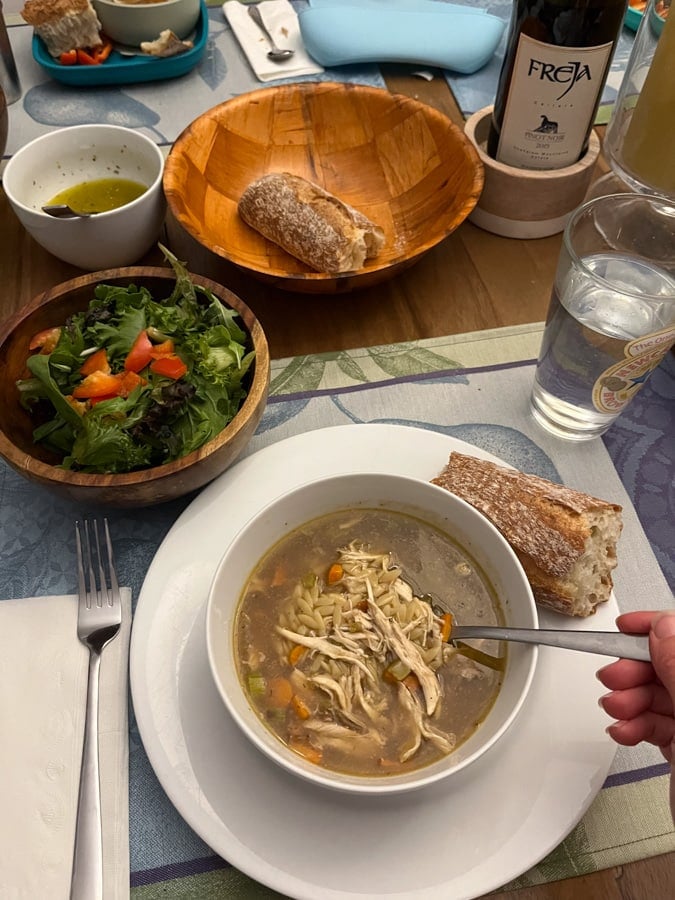 chicken soup with salad and bread