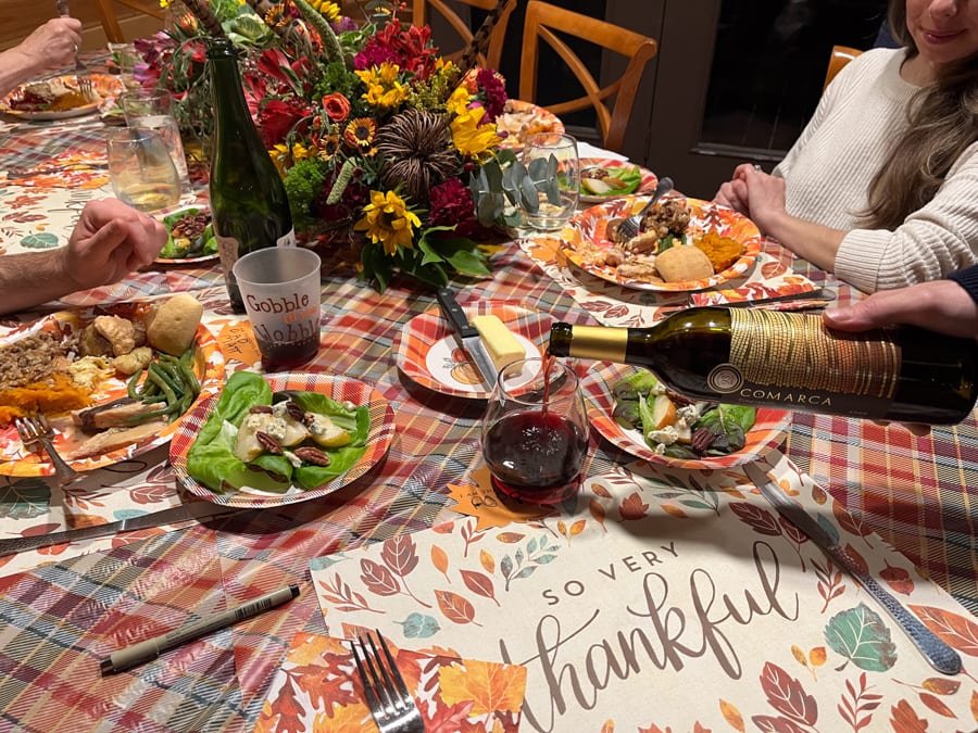 pouring red wine for thanksgiving dinner