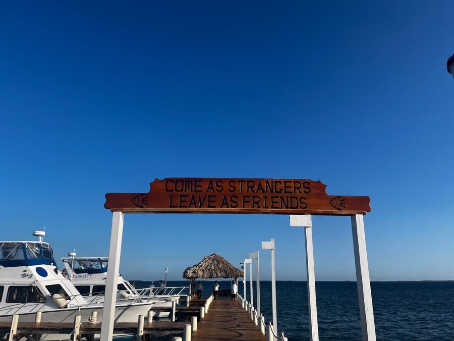 "come as strangers leave as friends" sign