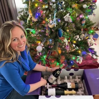 anne mauney with firstleaf wine and a christmas tree.