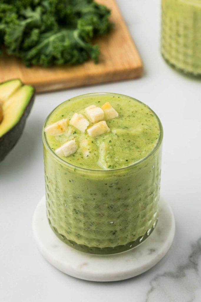 green avocado kale smoothie with pineapple in a short glass