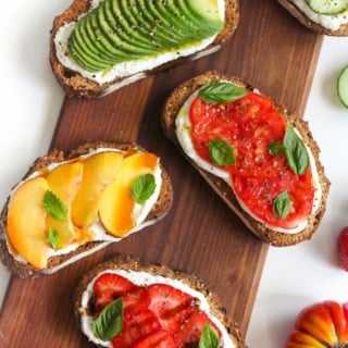 breakfast toast with ricotta cheese and fruit on a wooden platter