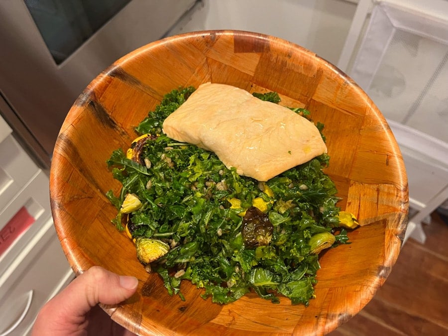 kale salad topped with salmon