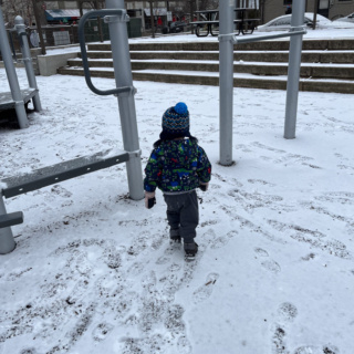 toddler in snowy playground