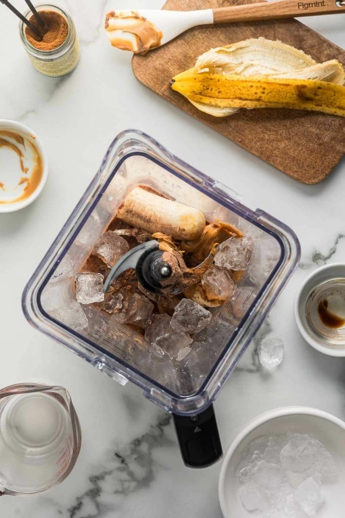 bananas, ice, peanut butter, and cocoa powder in a blender