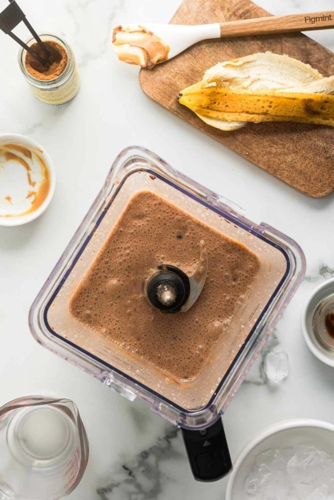 chocolate peanut butter smoothie with banana in a blender