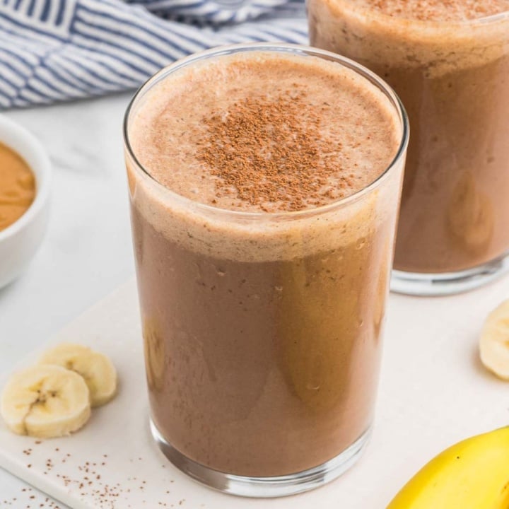 chocolate peanut butter banana smoothie with protein powder in a glass