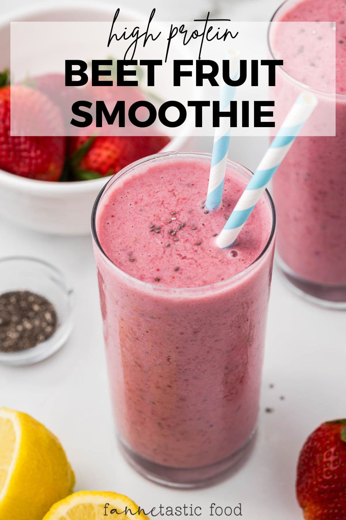 pink beet fruit smoothie in a glass with striped straws